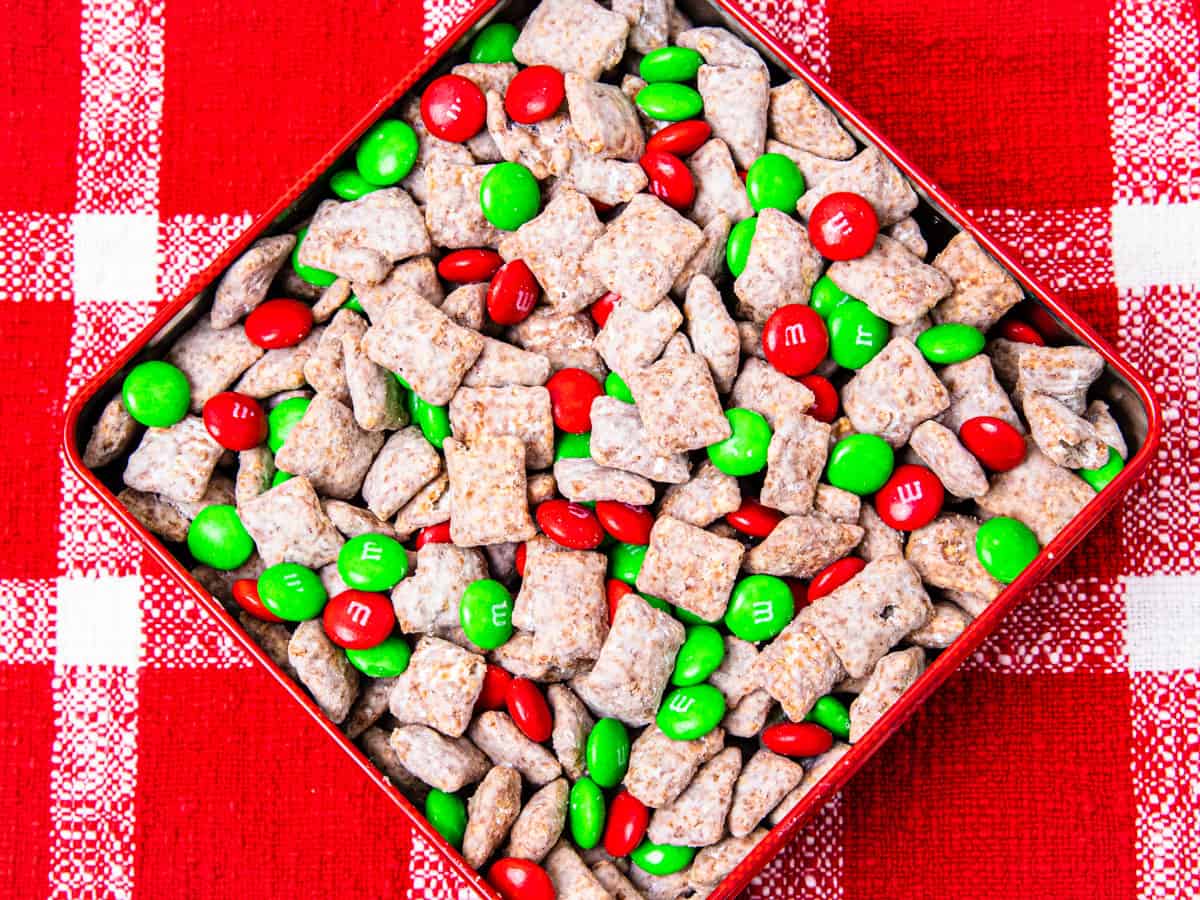 Overhead view of a tin container filled with Christmas puppy chow mix.