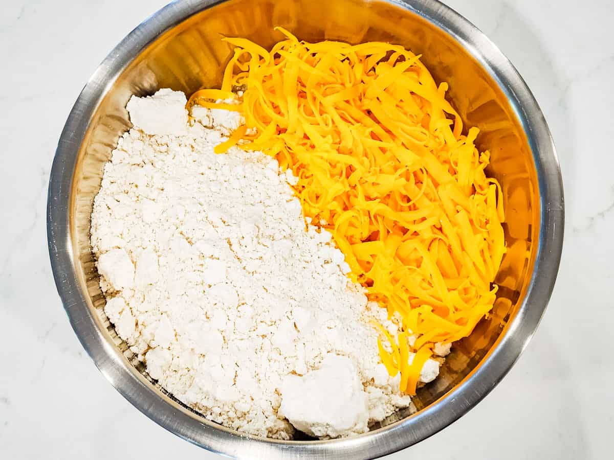 Bisquick mix and shredded cheese in a large mixing bowl.