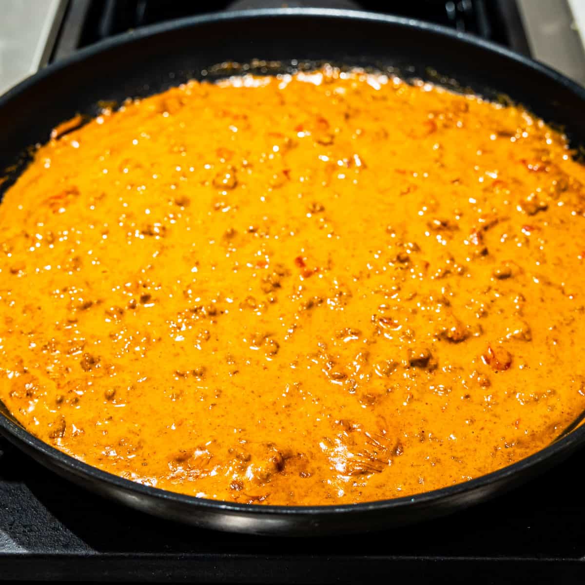 Chili cheese dip in a skillet.