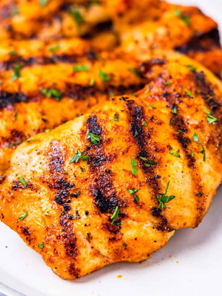 A plate of grilled boneless chicken thighs.