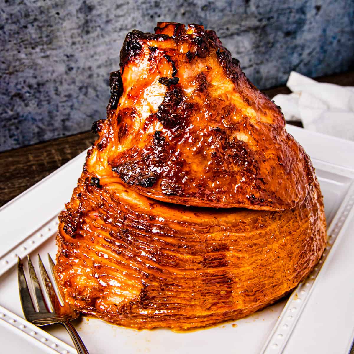 A double smoked spiral sliced ham served on a large platter.