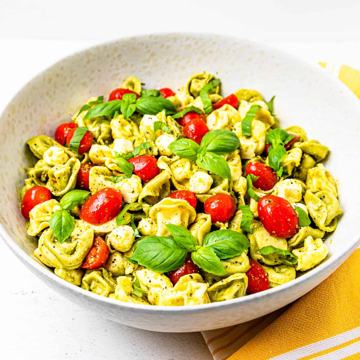 Pesto pasta salad in a large serving bowl.