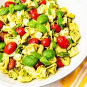 Tortellini pesto pasta salad in a large serving bowl.