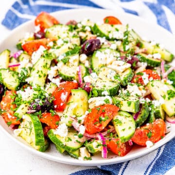 A large serving bowl filled with an authentic Greek salad.