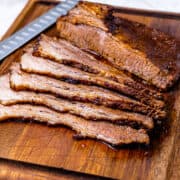 Sliced brisket on a cutting board.