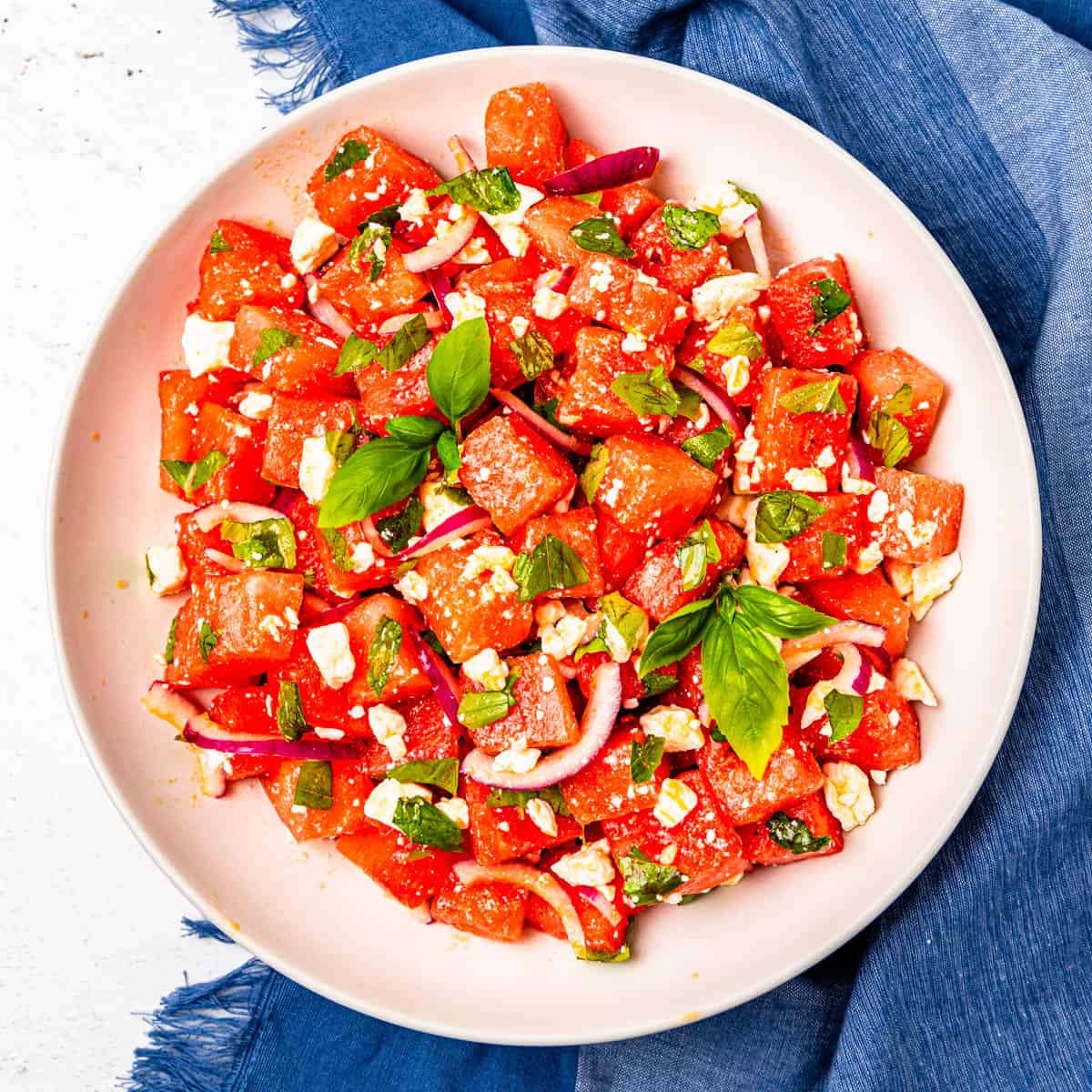 Watermelon and basil salad in a large serving bowl.