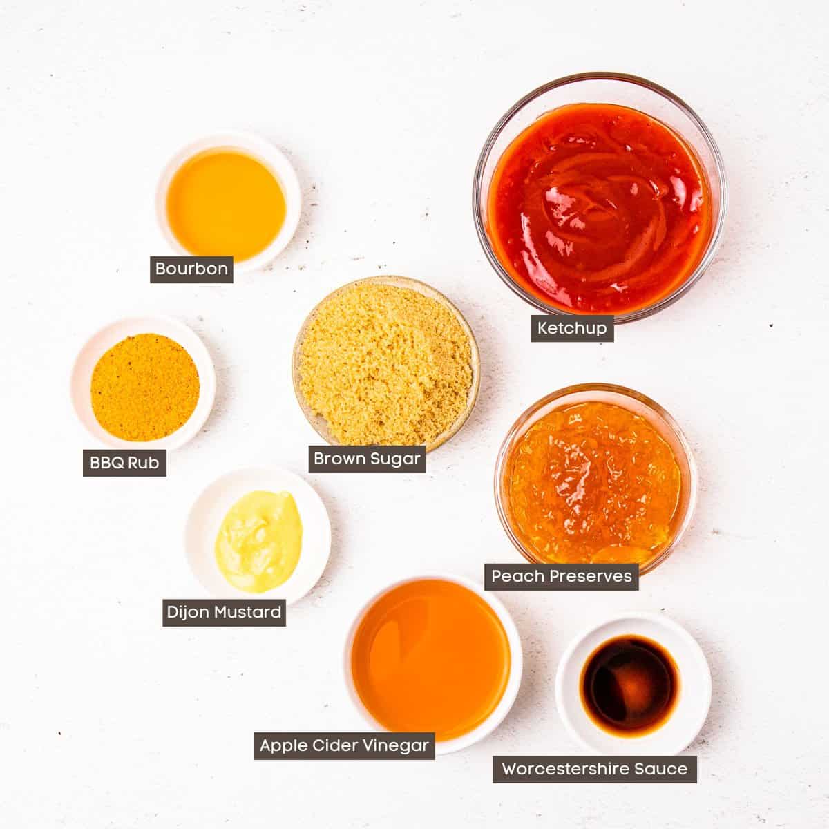 Ingredients for peach BBQ sauce in individual bowls arranged on a countertop.