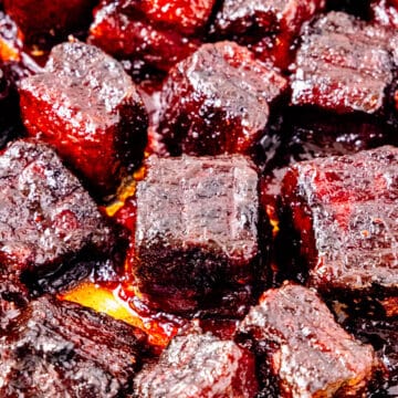 Smoked pork belly burnt ends in a pan.