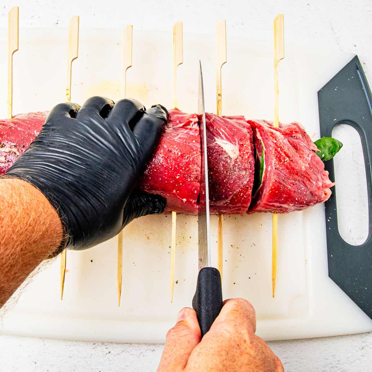 Steak pinwheels being sliced.