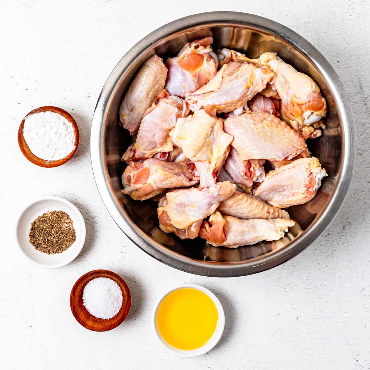 Ingredients for air fryer chicken wings set on a countertop. 