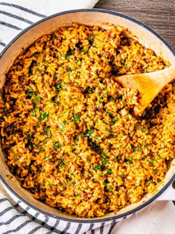 A large pot filled with cajun dirty rice sitting on a table.