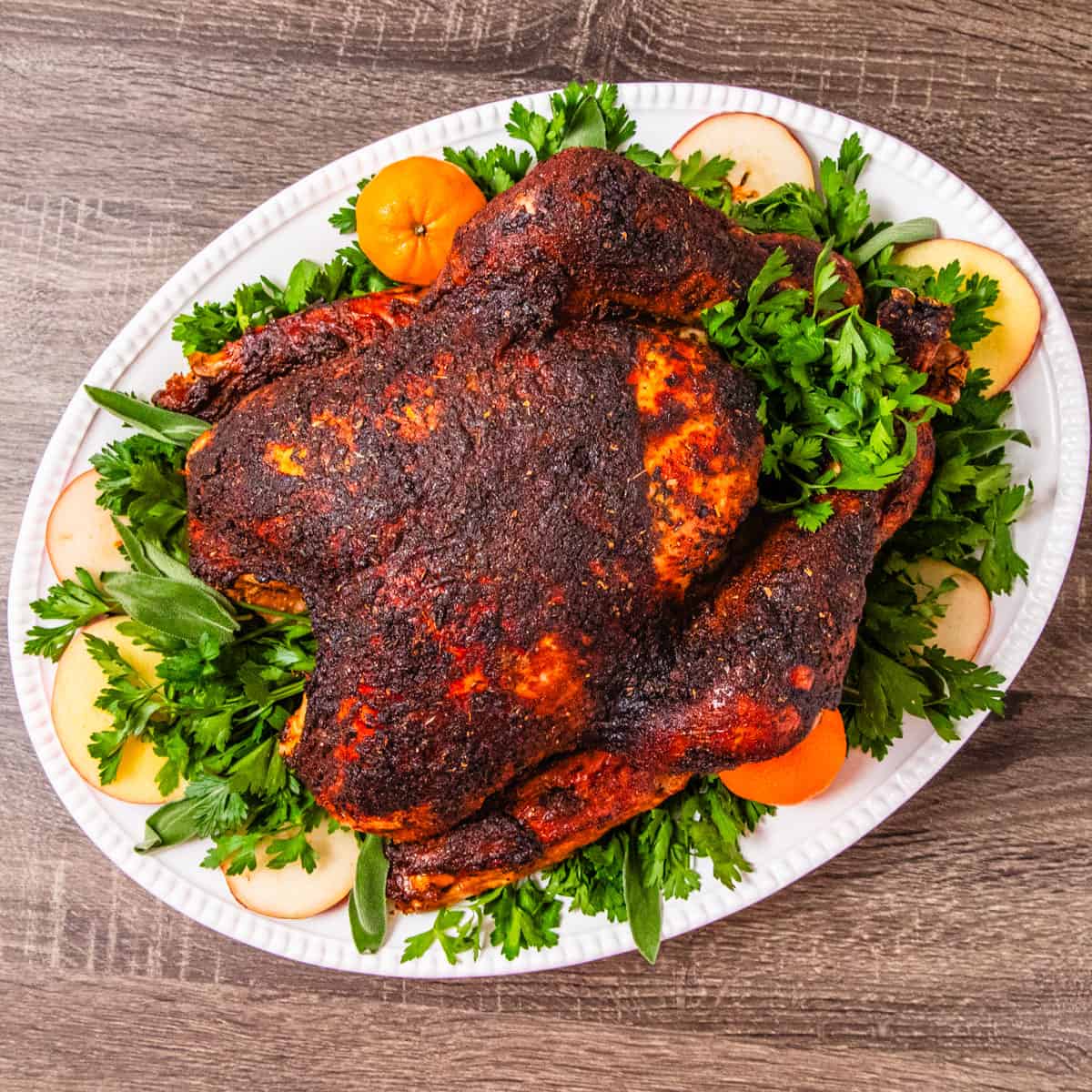 A roasted turkey seasoned with Creole seasoning served on a large platter.