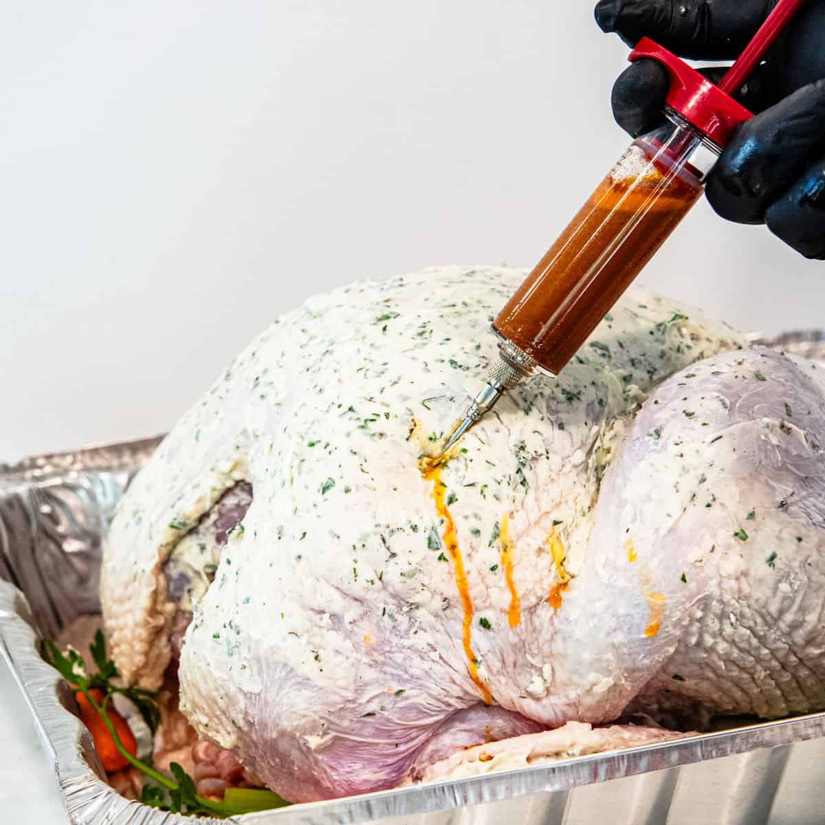 A  turkey being injected with seasoning marinade.