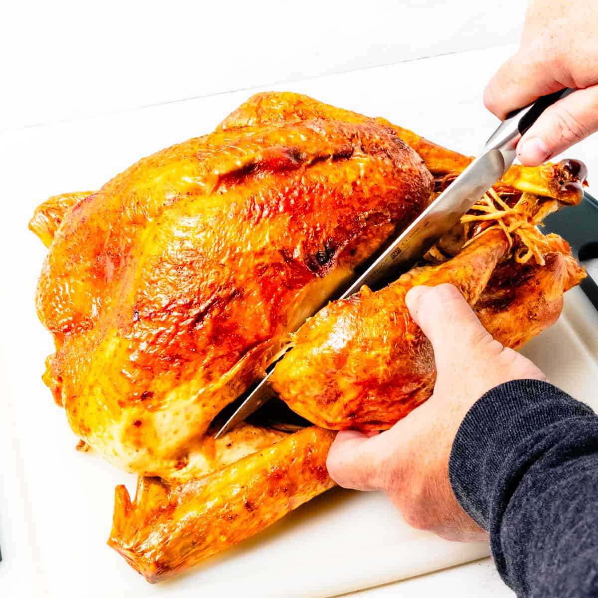 Carving a turkey between the breast and leg.