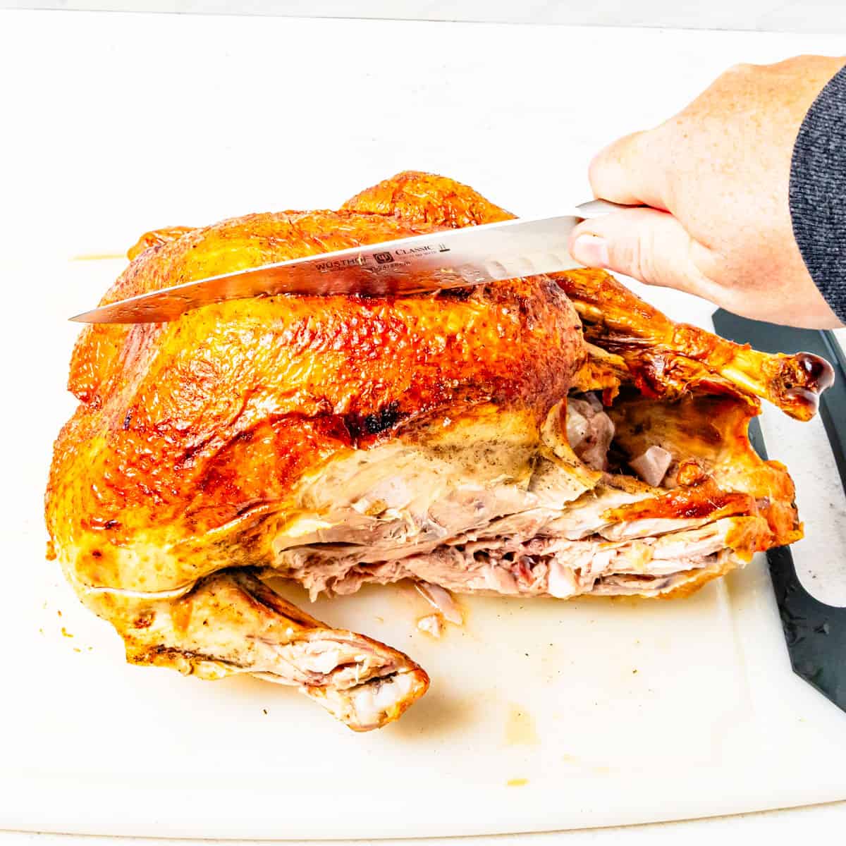 Cutting into a turkey at the breast bone. 