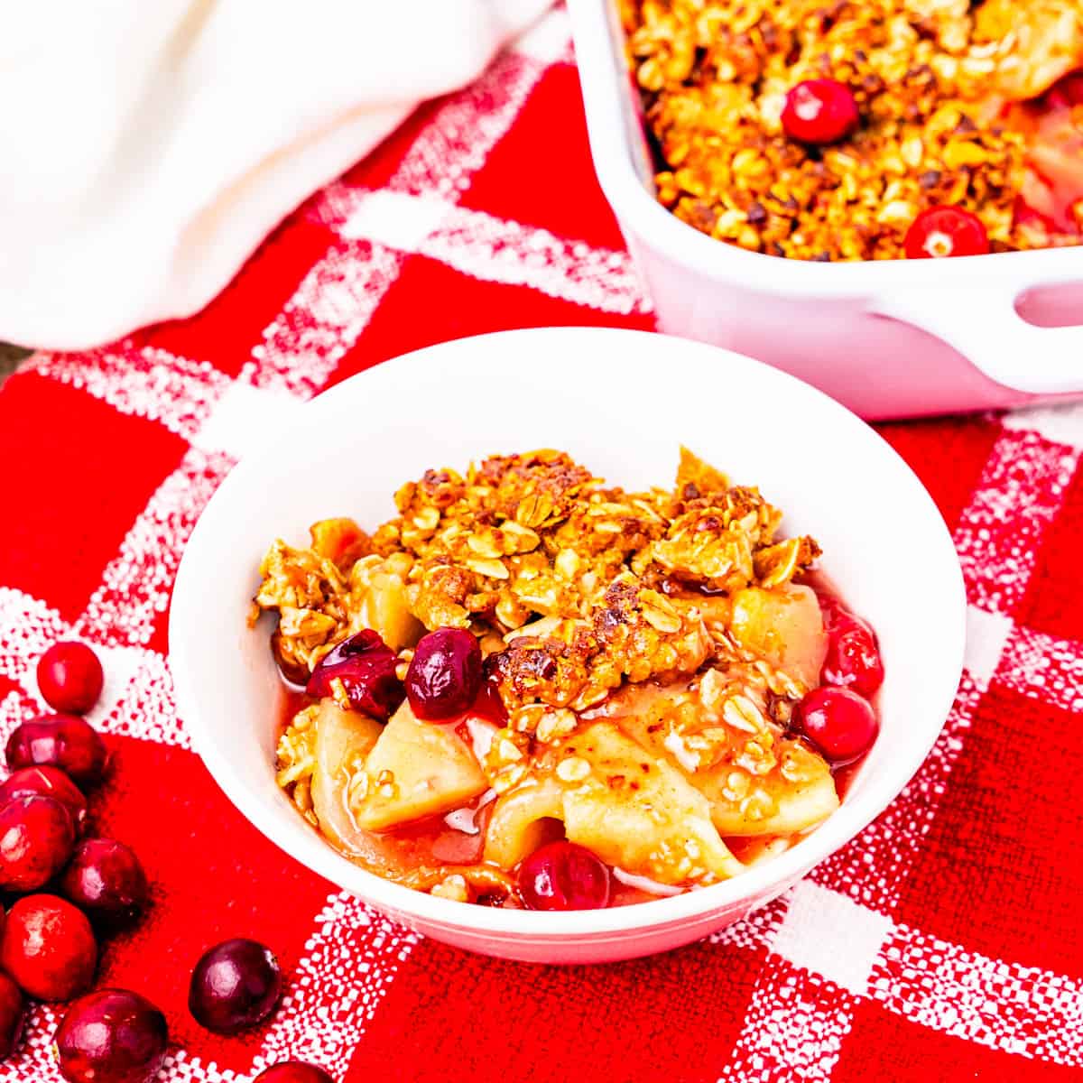 A serving of cranberry apple crisp in a bowl.