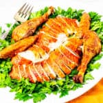 Sliced roasted turkey served on a large platter.