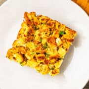 A square serving of stuffing on a small plate.