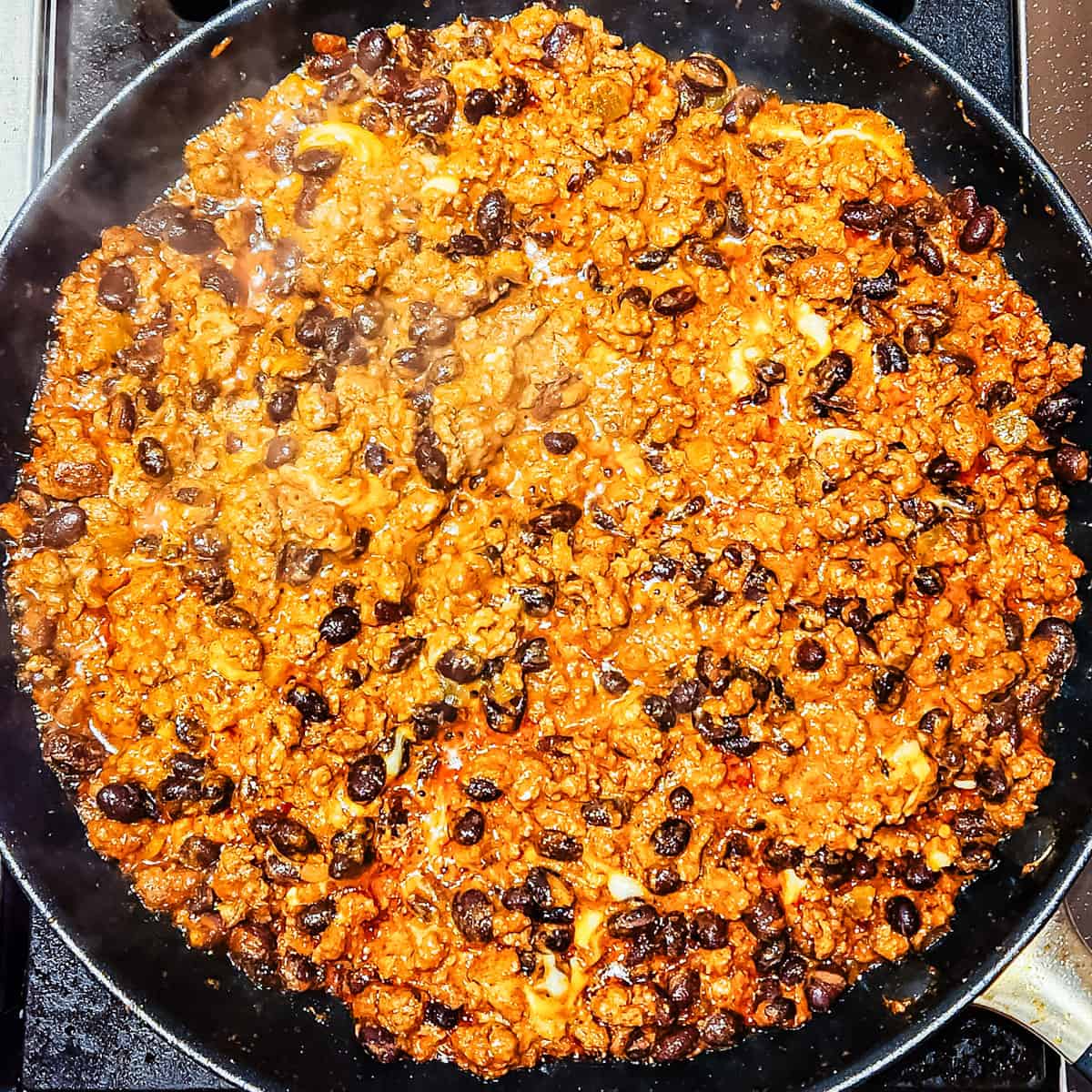 Beef enchilada filling in a pan.