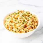 A bowl of rice pilaf on a countertop.