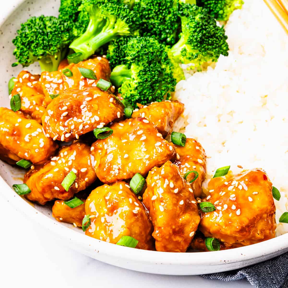 A serving of orange chicken on a plate. 