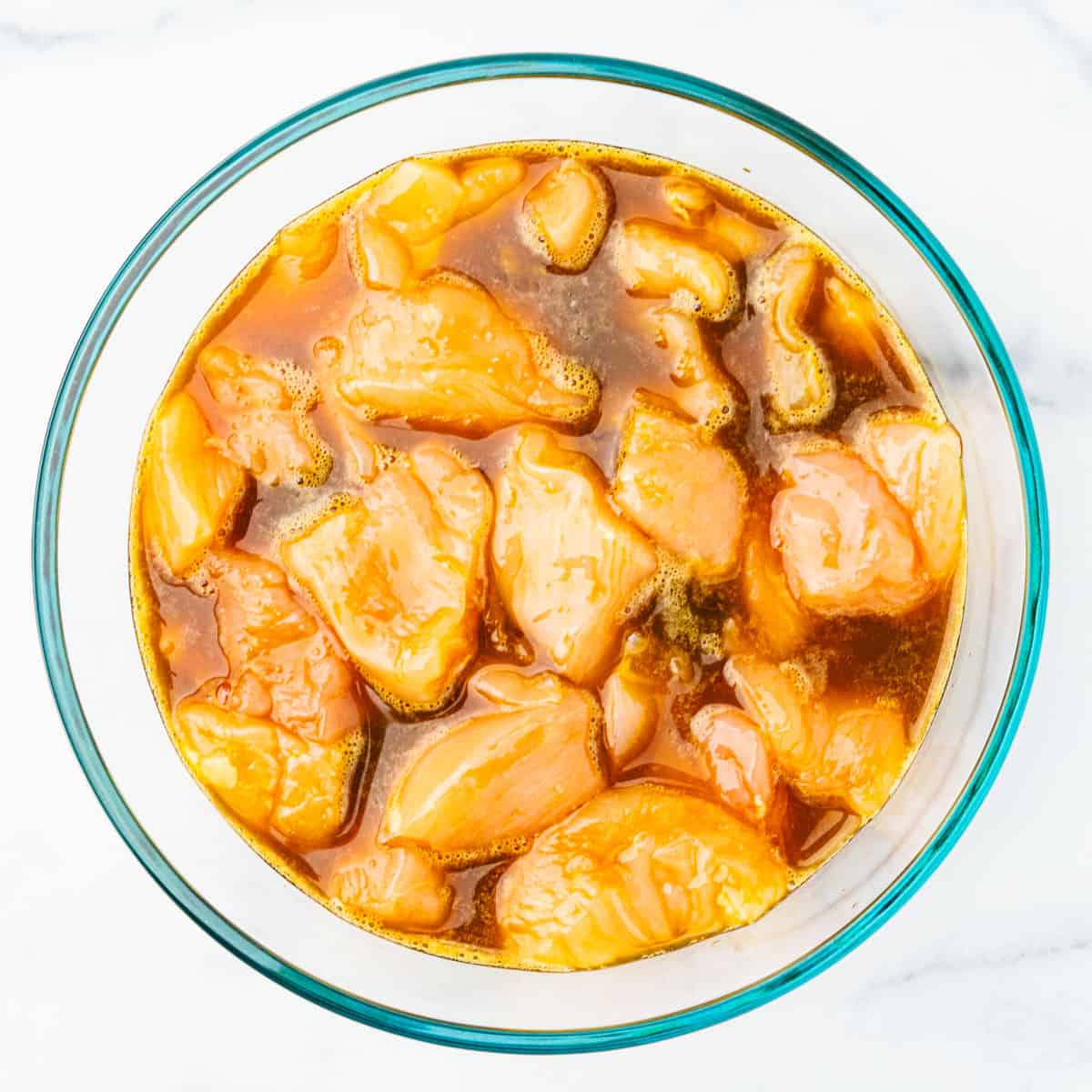 Chicken marinating in a bowl. 