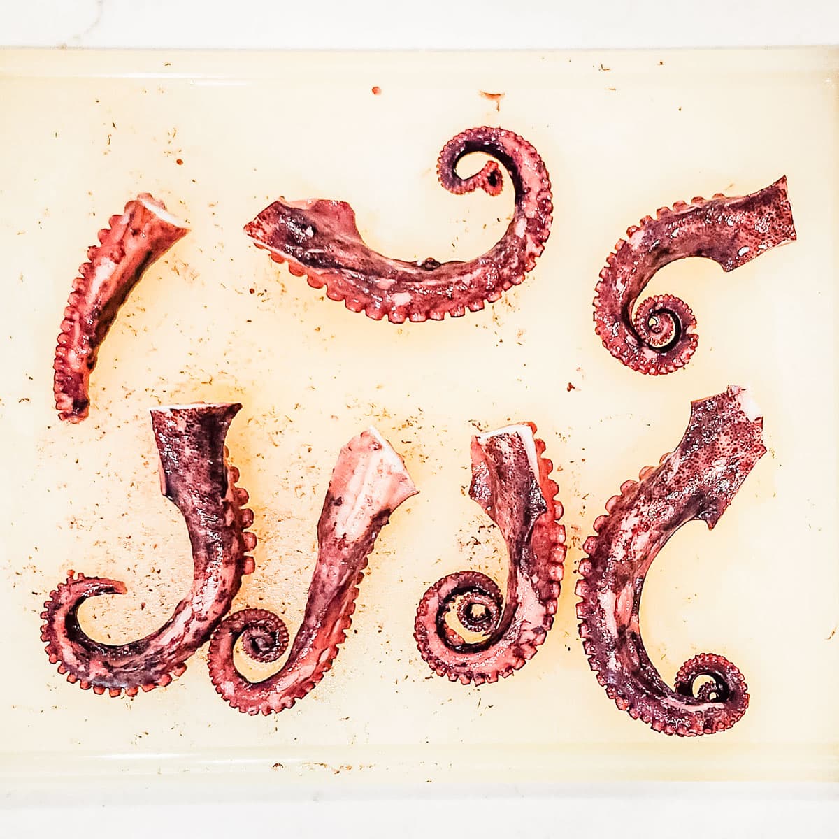 Octopus legs on a cutting board.