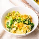 A small bowl of broccoli cheese casserole.