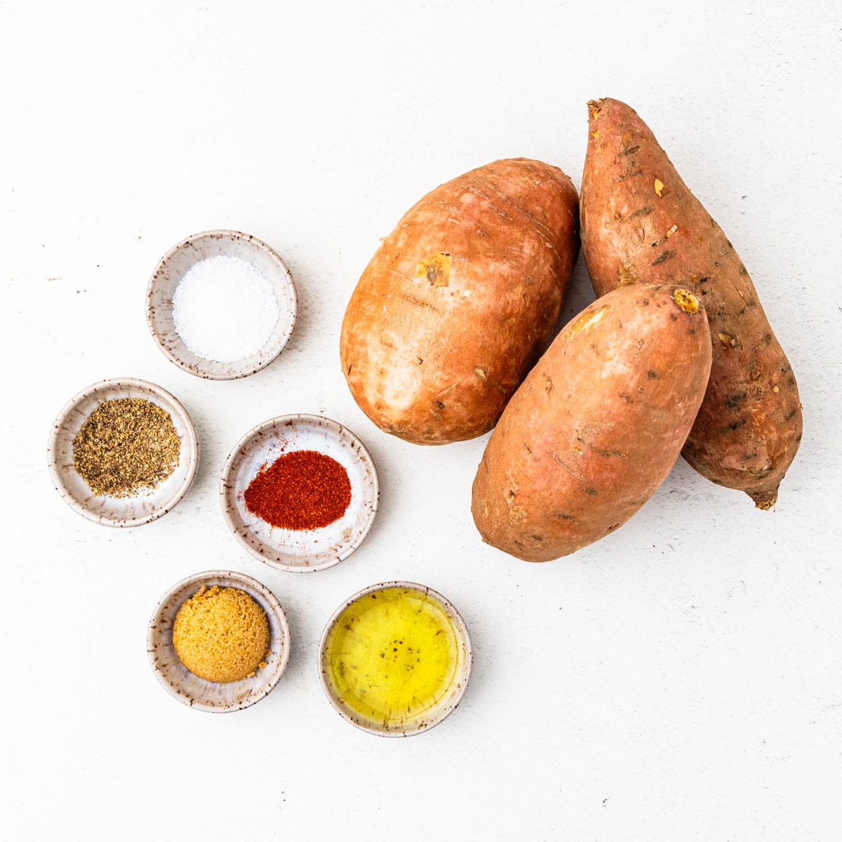 Ingredients for sweet potato wedges arranged on a countertop.