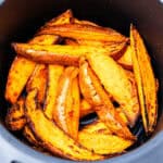 Sweet potato wedges in an air fryer.
