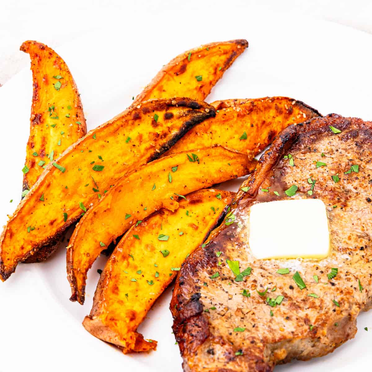 Sweet potato wedges served with steak.
