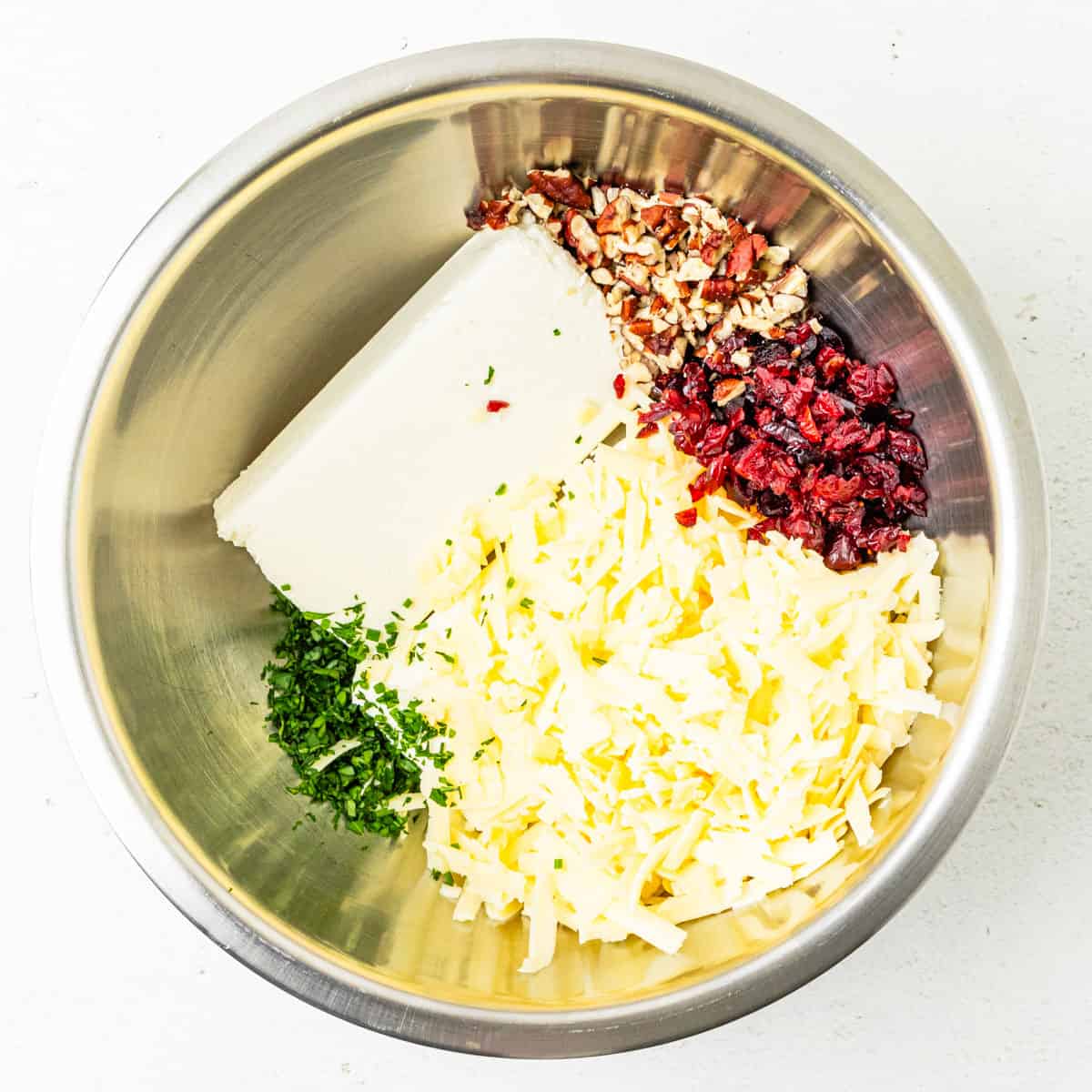 Cheese ball ingredients in a mixing bowl before mixing.