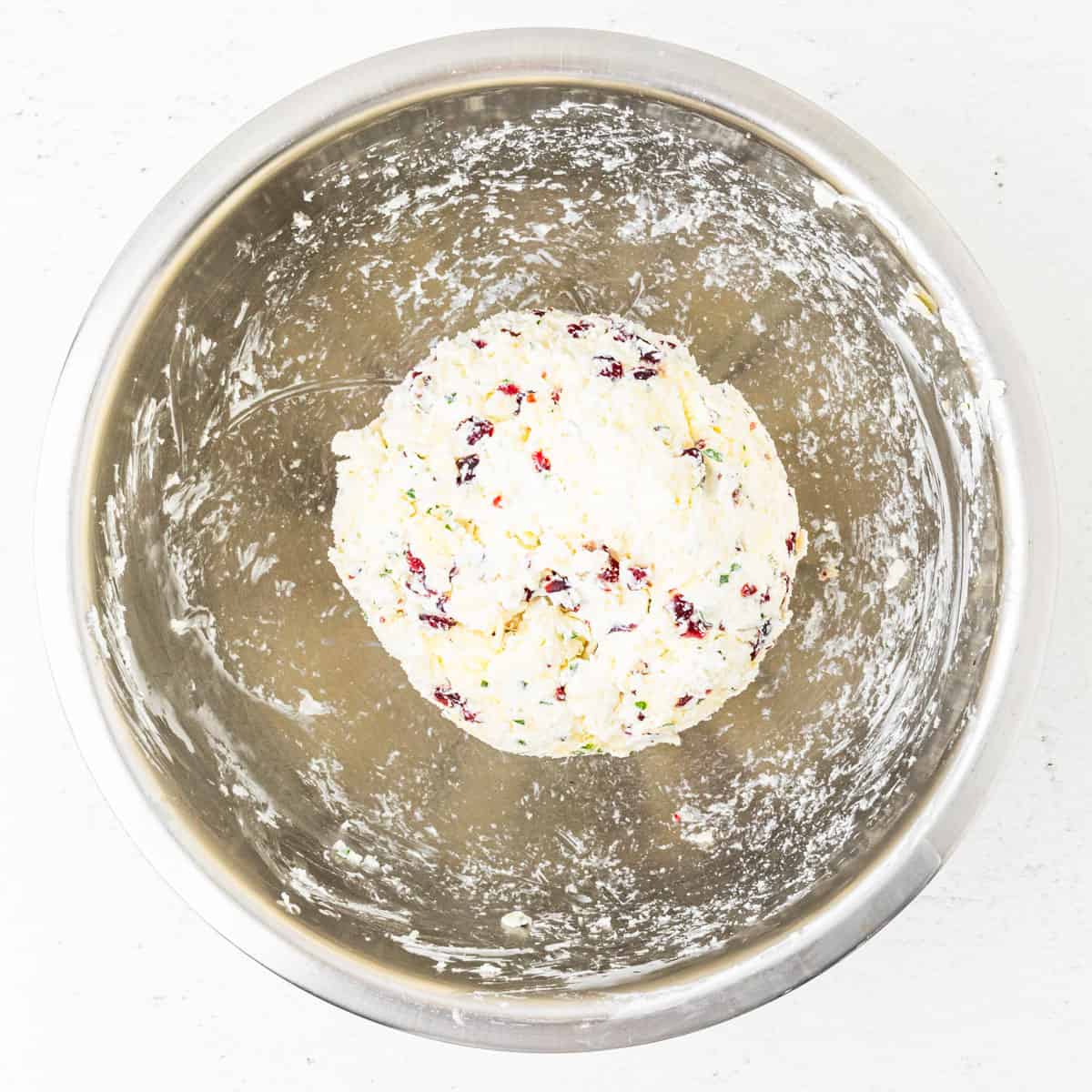Cheese ball in a mixing bowl after mixing the ingredients and shaping.