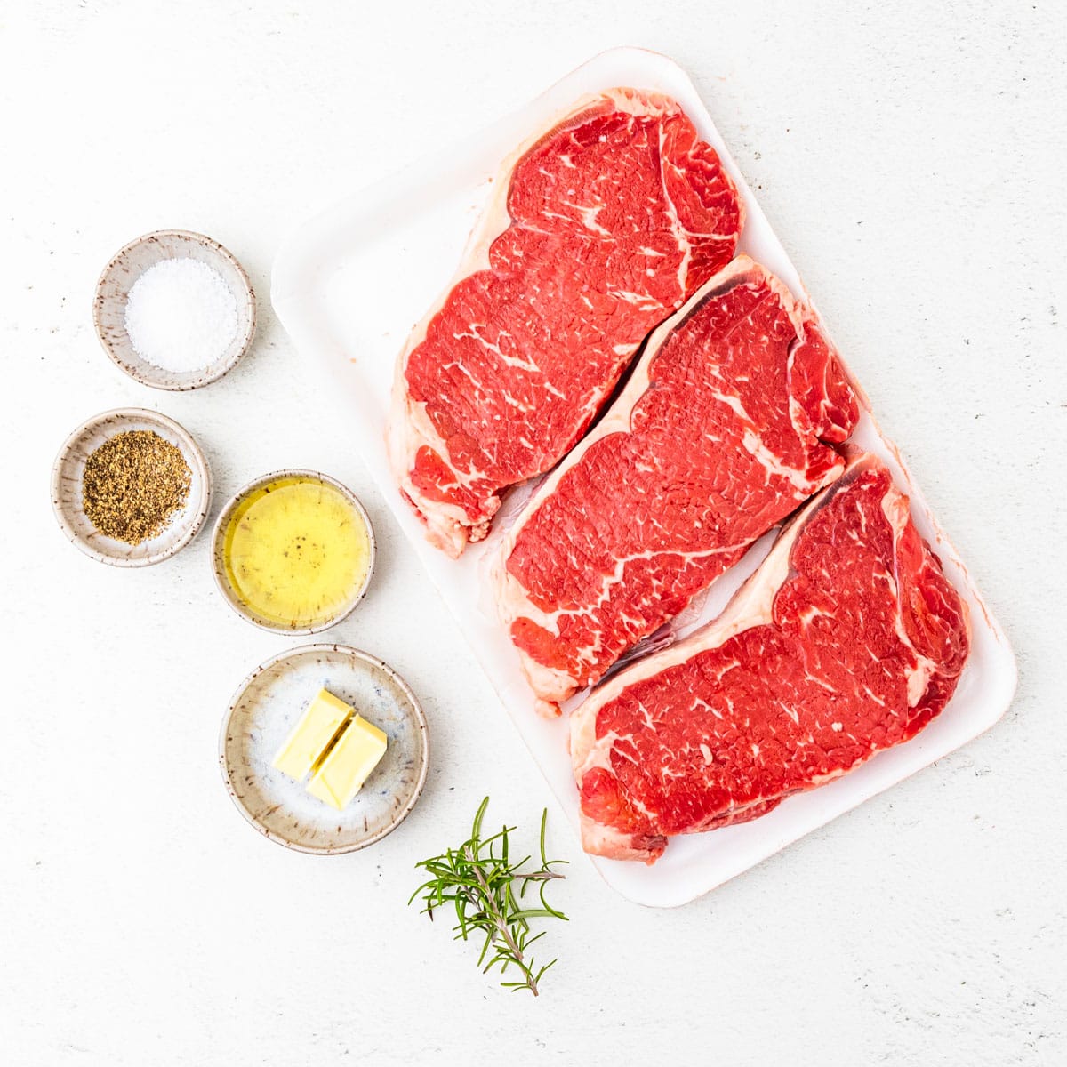 Ingredients for pan seared steak arranged on a countertop.