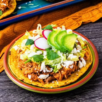 Chicken tinga tostadas on a plate.
