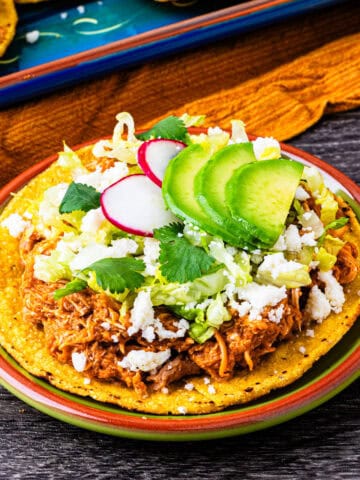 Chicken tinga tostadas on a plate.