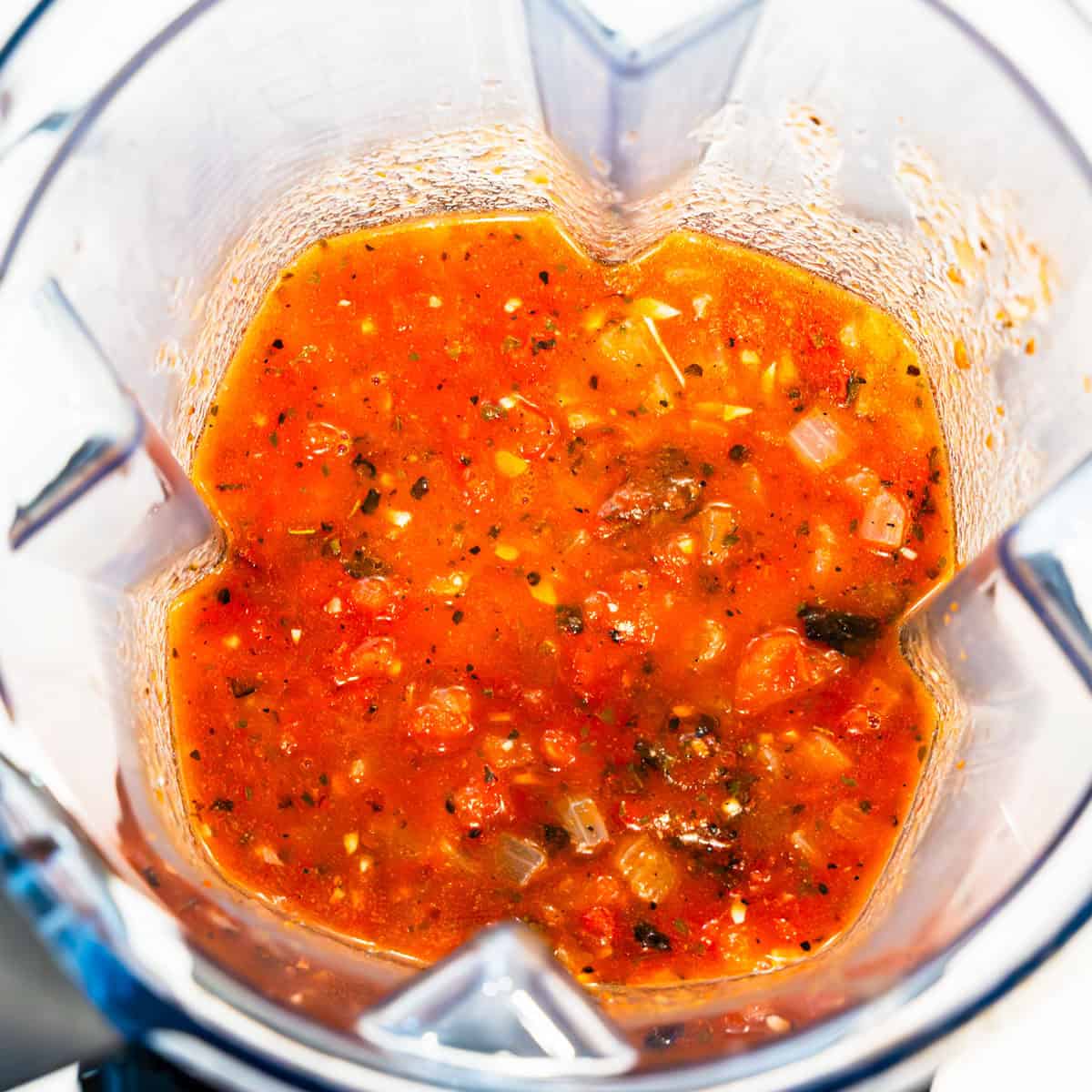 Chicken tinga sauce in a blender before being blended. 