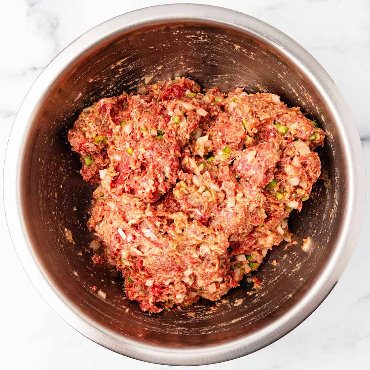 Meatloaf mixture in a mixing bowl.