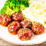 Meatloaf meatballs served on a plate with mashed potatoes and broccoli.