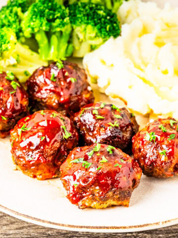 Meatloaf meatballs served on a plate with mashed potatoes and broccoli.