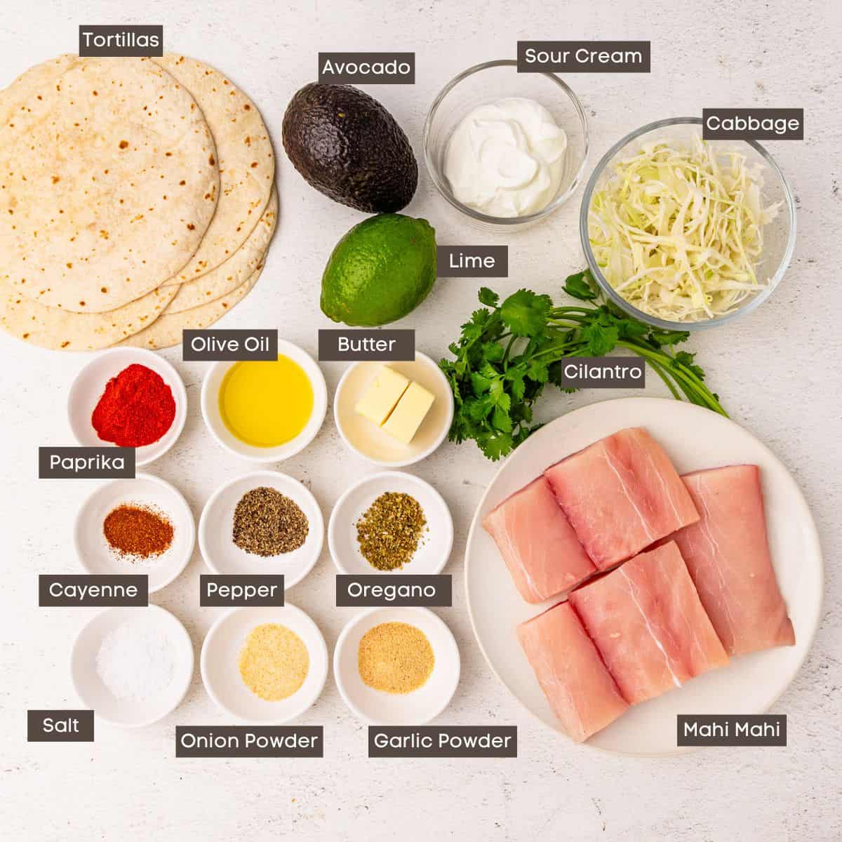 Ingredients for fish tacos arranged on a countertop.