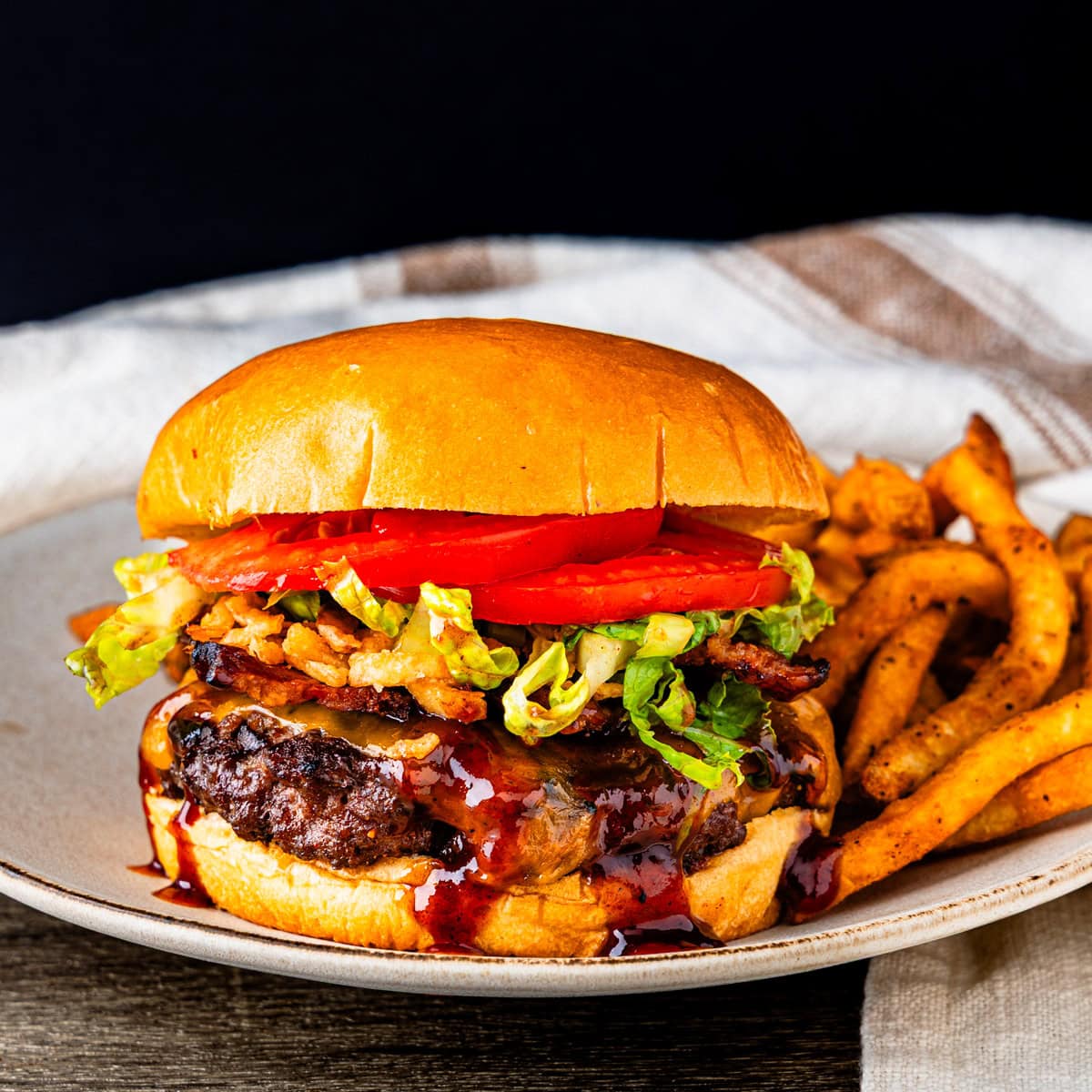 A western bacon cheeseburger served with fries.