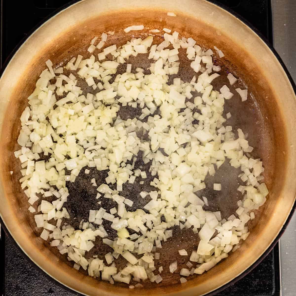 Diced onion cooking in a pot.