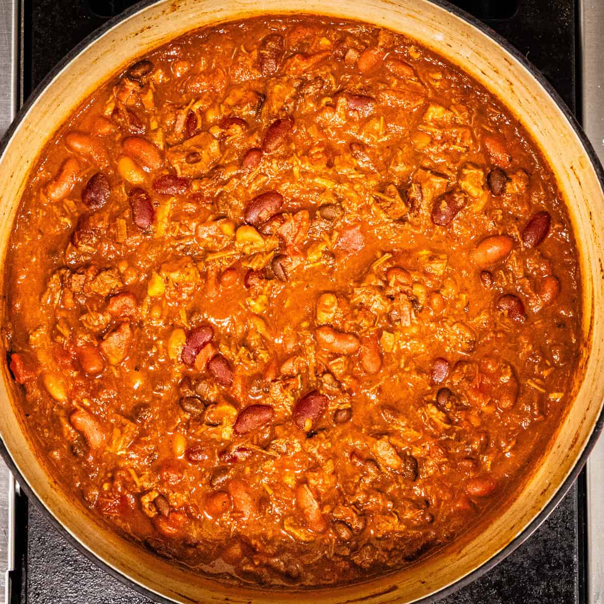 Brisket chili in a pot after being cooked down and thickened.