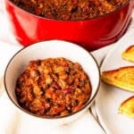A bowl of brisket chili on a table.