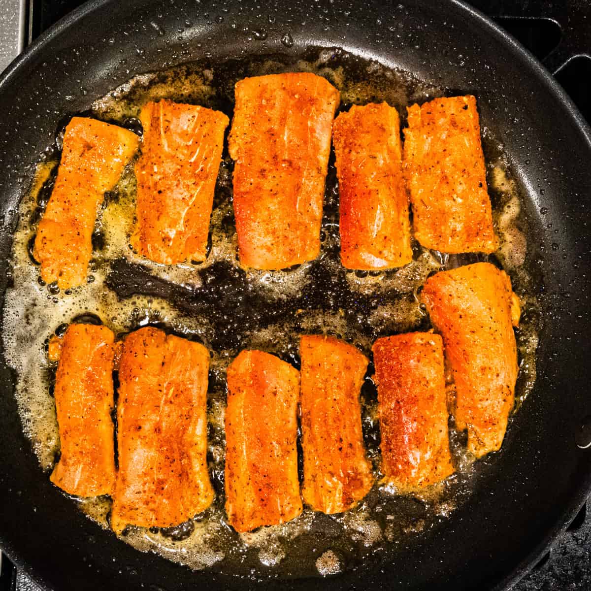 Mahi mahi cooking in a skillet.