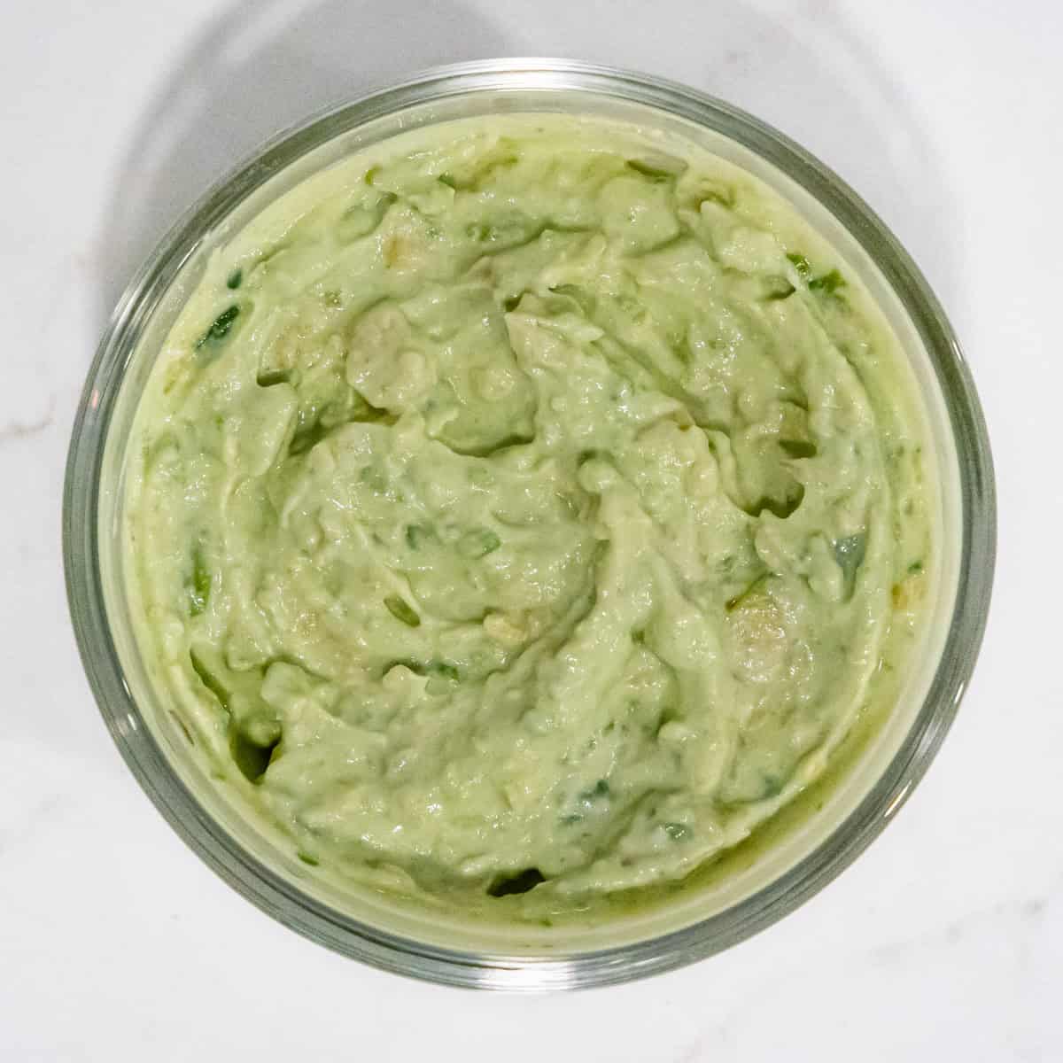 Avocado lime cream sauce in a small mixing bowl.