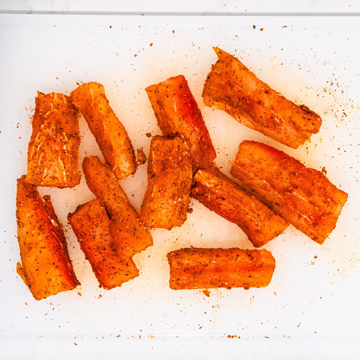 Seasoned mahi mahi on a cutting board.
