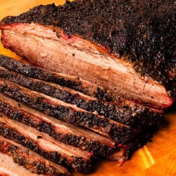 Smoked brisket flat sliced on a cutting board.