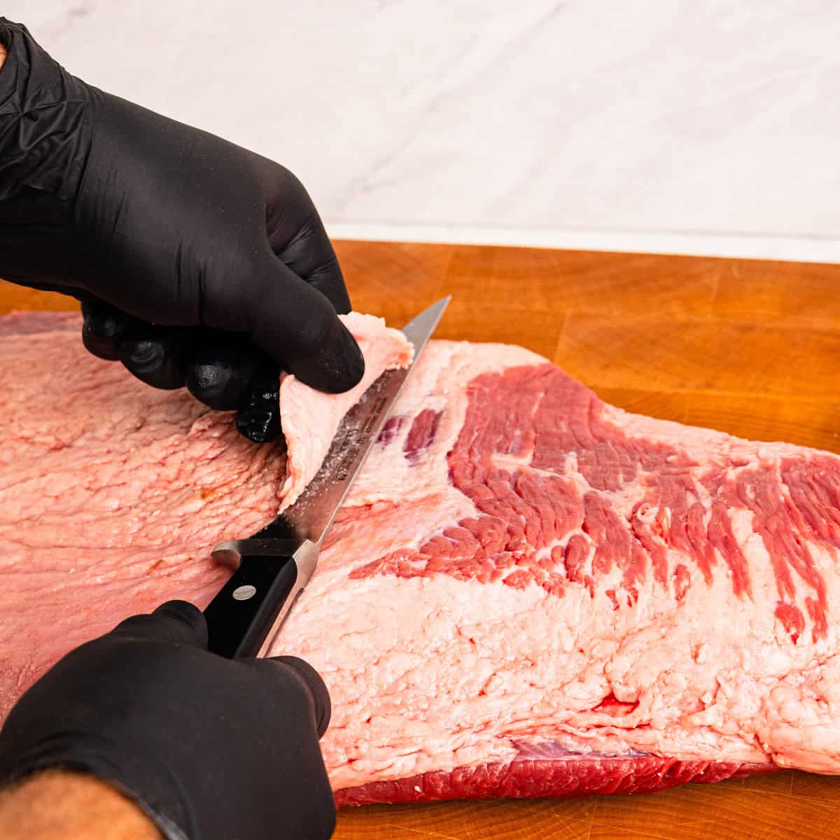 Trimming fat cap on a brisket flat.